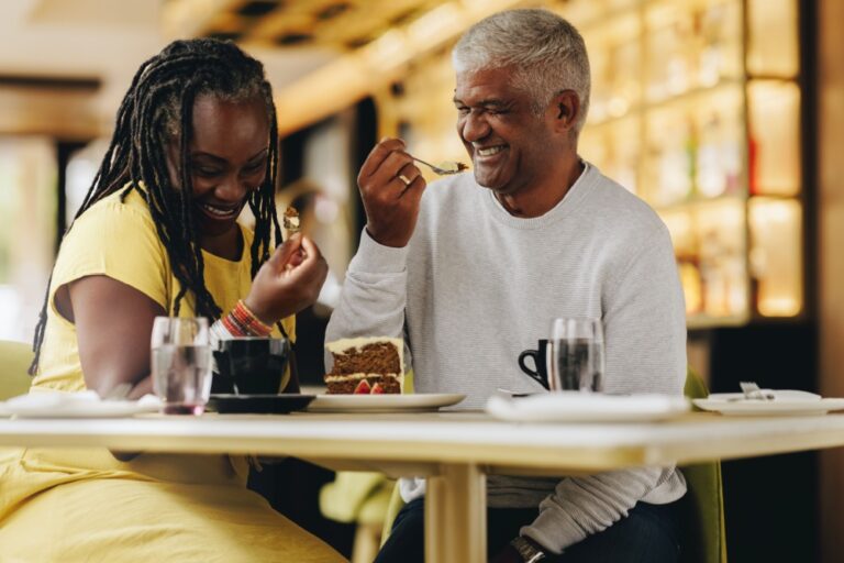 A couple laughing together at a café.