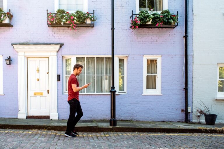 A man walking past the front door of a house.