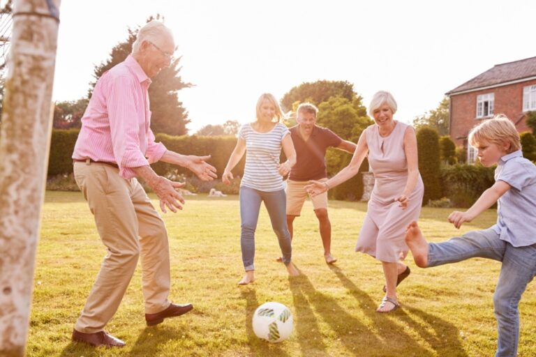 A family playing football in a garden.