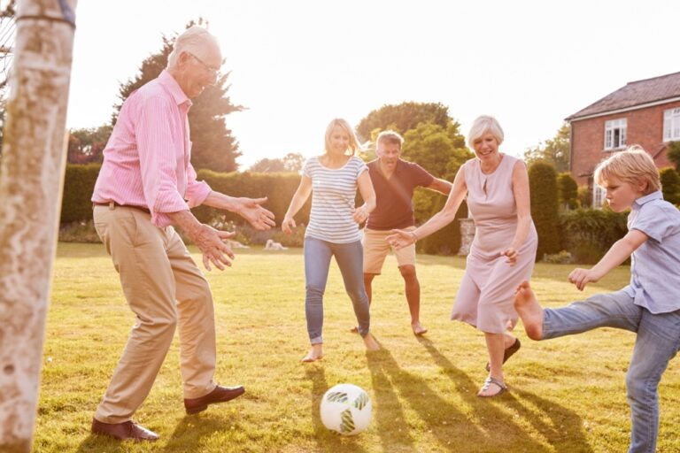 A family playing football in a garden.
