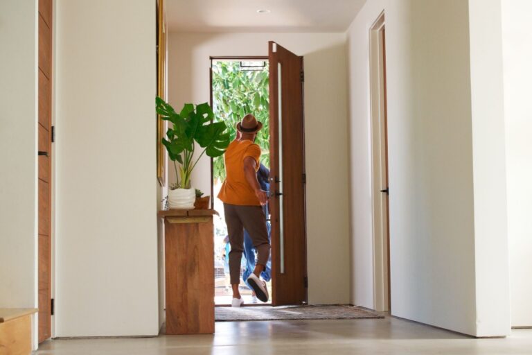 A family leaving the front door of their home.