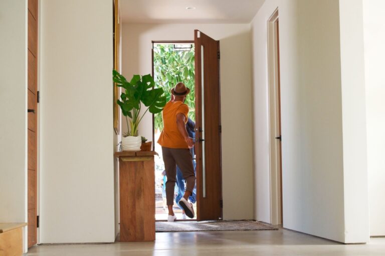 A family leaving the front door of their home.