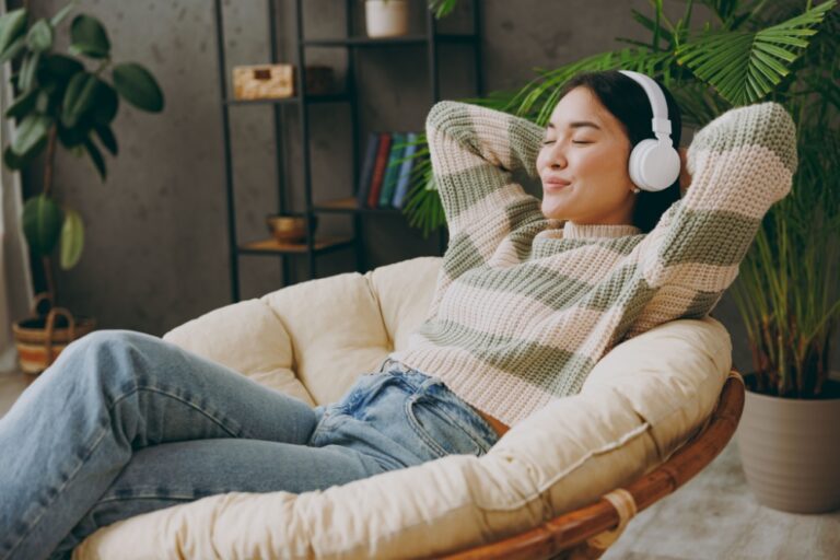 A woman relaxing with headphones on.