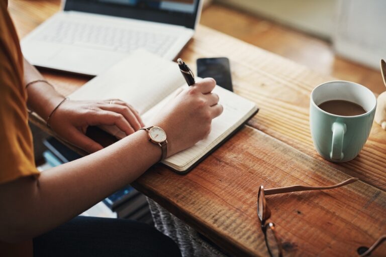 A woman making notes in a diary.